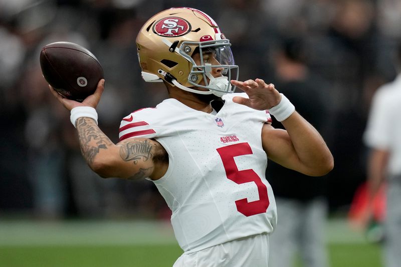 San Francisco 49ers quarterback Trey Lance (5) warms up prior to an NFL preseason football game against the Las Vegas Raiders, Sunday, Aug. 13, 2023, in Las Vegas. (AP Photo/John Locher)