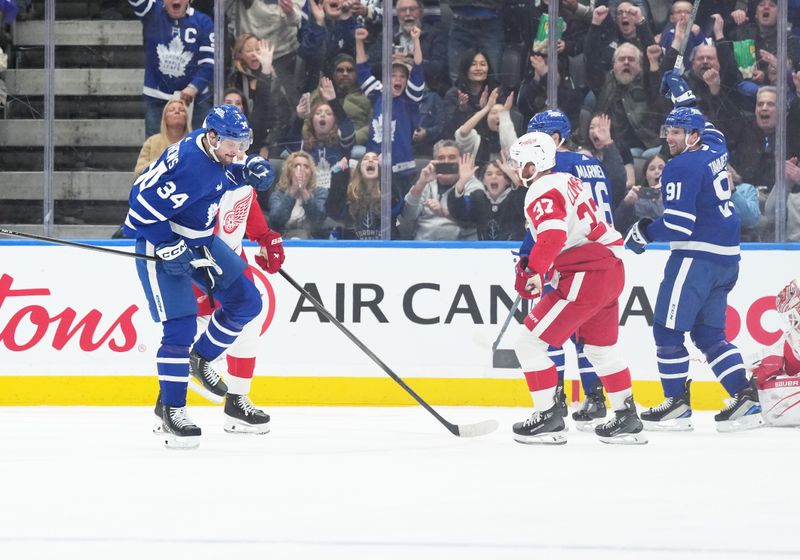 Apr 13, 2024; Toronto, Ontario, CAN; Toronto Maple Leafs center Auston Matthews (34) scores his 69th goal of the season and celebrates against the Detroit Red Wings during the second period at Scotiabank Arena. Mandatory Credit: Nick Turchiaro-USA TODAY Sports