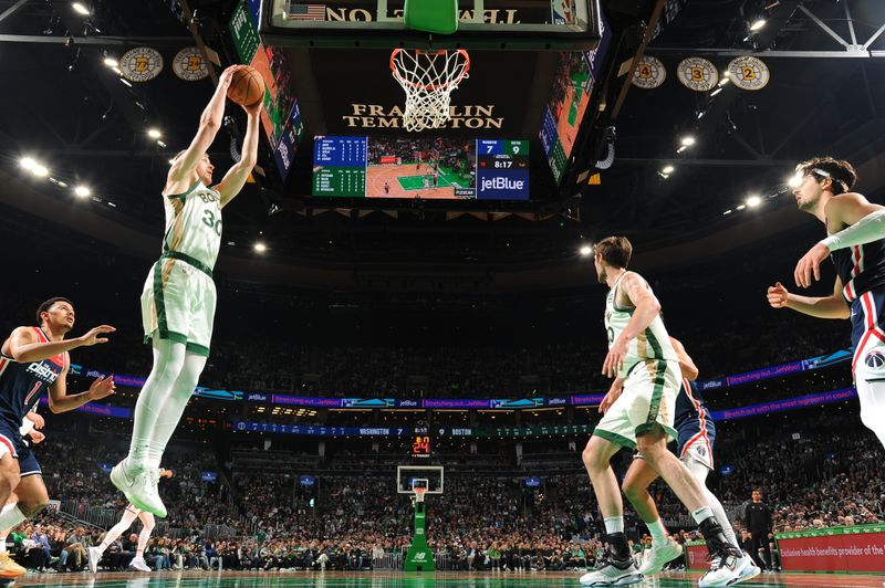 BOSTON, MA - APRIL 14: Sam Hauser #30 of the Boston Celtics grabs a rebound during the game against the Washington Wizards on April 14, 2024 at the TD Garden in Boston, Massachusetts. NOTE TO USER: User expressly acknowledges and agrees that, by downloading and or using this photograph, User is consenting to the terms and conditions of the Getty Images License Agreement. Mandatory Copyright Notice: Copyright 2024 NBAE  (Photo by Brian Babineau/NBAE via Getty Images)