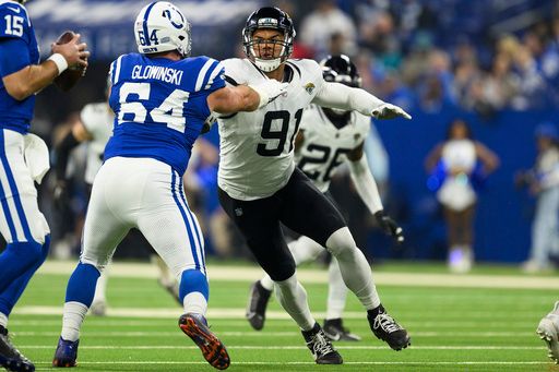 Indianapolis Colts center Mark Glowinski (64) blocks Jacksonville Jaguars defensive end Arik Armstead (91) during an NFL football game, Sunday, Jan. 5, 2025, in Indianapolis. The Colts defeated the Jaguars 26-23. (AP Photo/Zach Bolinger)