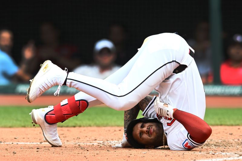 Jul 25, 2024; Cleveland, Ohio, USA; Cleveland Guardians shortstop Brayan Rocchio (4) lies on the ground after being hit by a pitch during the eighth inning against the Detroit Tigers at Progressive Field. Mandatory Credit: Ken Blaze-USA TODAY Sports