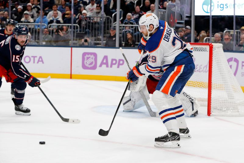 Nov 13, 2025; Columbus, Ohio, USA; Edmonton Oilers center Leon Draisaitl (29) receives a pass in front of Columbus Blue Jackets defenseman Dante Fabbro (15) during the first period at Nationwide Arena. Mandatory Credit: Russell LaBounty-Imagn Images