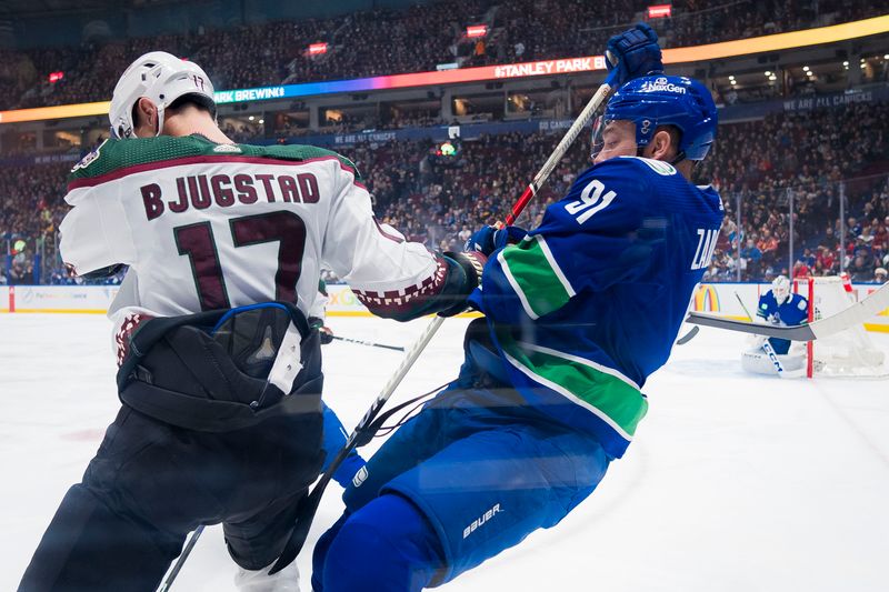 Jan 18, 2024; Vancouver, British Columbia, CAN; Arizona Coyotes forward Nick Bjugstad (17) collides with Vancouver Canucks defenseman Nikita Zadorov (91) in the first period at Rogers Arena. Mandatory Credit: Bob Frid-USA TODAY Sports