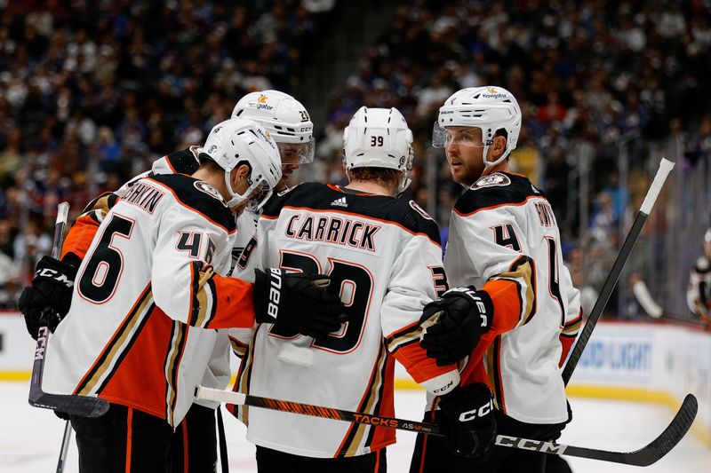 Dec 5, 2023; Denver, Colorado, USA; Anaheim Ducks center Sam Carrick (39) celebrates his goal with defenseman Ilya Lyubushkin (46) and right wing Brett Leason (20) and defenseman Cam Fowler (4) in the third period against the Colorado Avalanche at Ball Arena. Mandatory Credit: Isaiah J. Downing-USA TODAY Sports