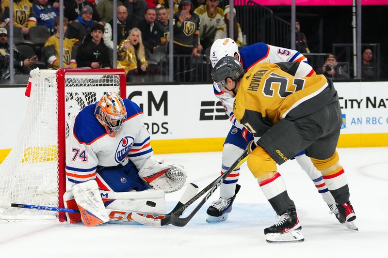 Feb 6, 2024; Las Vegas, Nevada, USA; Edmonton Oilers goaltender Stuart Skinner (74) makes a save against Vegas Golden Knights center Brett Howden (21) during the first period at T-Mobile Arena. Mandatory Credit: Stephen R. Sylvanie-USA TODAY Sports