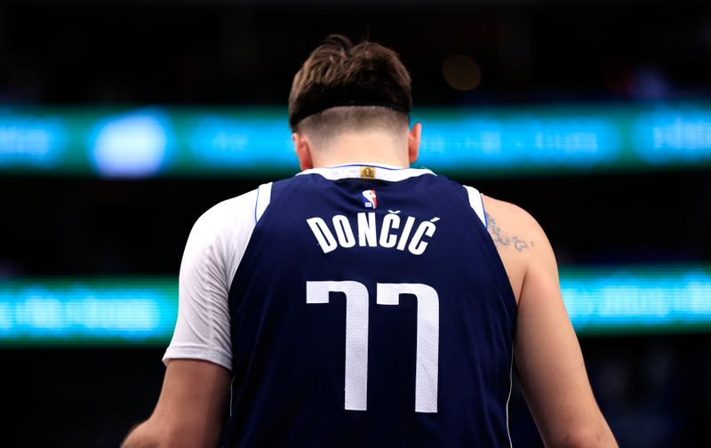 DALLAS, TX - JANUARY 27: Luka Doncic #77 of the Dallas Mavericks looks down during a break in the action against the Sacramento Kings in the second half at American Airlines Center on January 27, 2024 in Dallas, Texas. NOTE TO USER: User expressly acknowledges and agrees that, by downloading and or using this photograph, User is consenting to the terms and conditions of the Getty Images License Agreement. (Photo by Ron Jenkins/Getty Images)