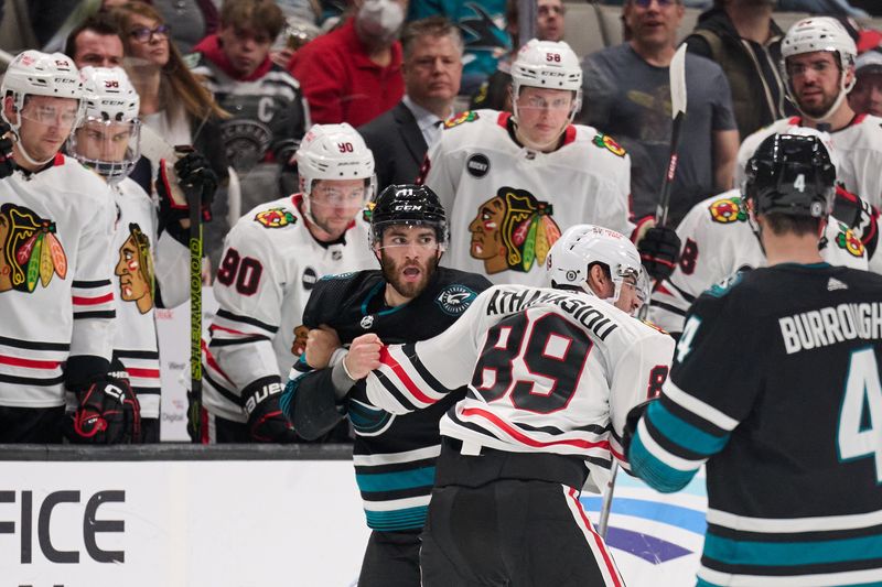 Mar 23, 2024; San Jose, California, USA; San Jose Sharks center Luke Kunin (11) fights against Chicago Blackhawks center Andreas Athanasiou (89) during the first period at SAP Center at San Jose. Mandatory Credit: Robert Edwards-USA TODAY Sports