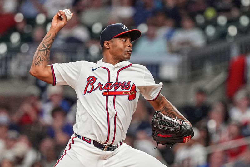 May 7, 2024; Cumberland, Georgia,USA; Atlanta Braves relief pitcher Raisel Iglesias (26) pitches against the Boston Red Sox during the ninth inning at Truist Park. Mandatory Credit: Dale Zanine-USA TODAY Sports