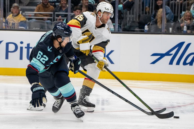 Nov 8, 2024; Seattle, Washington, USA;  Seattle Kraken defenseman Brandon Montour (62) and Vegas Golden Knights defenseman Noah Hanifin (15) battle for the puck during the second period at Climate Pledge Arena. Mandatory Credit: Stephen Brashear-Imagn Images