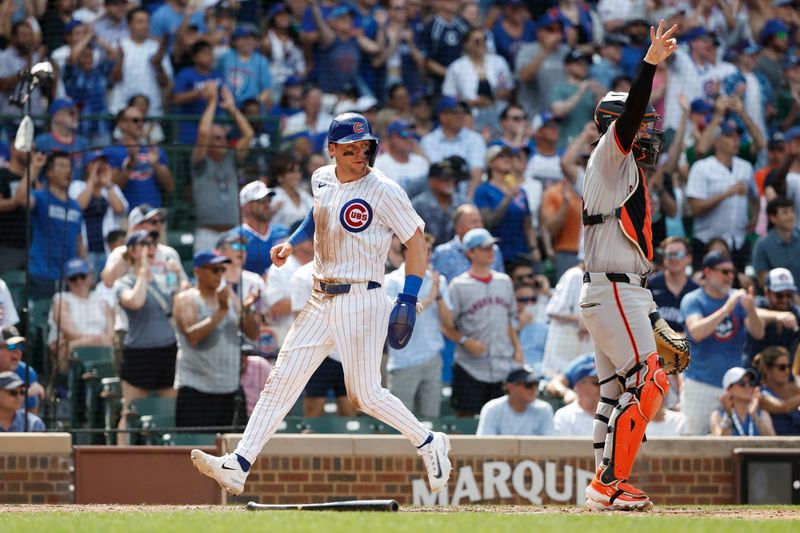 Jun 19, 2024; Chicago, Illinois, USA; Chicago Cubs second baseman Nico Hoerner (2) scores against the San Francisco Giants during the seventh inning at Wrigley Field. Mandatory Credit: Kamil Krzaczynski-USA TODAY Sports