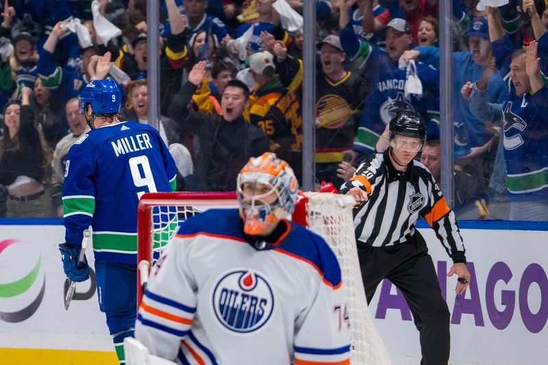 May 8, 2024; Vancouver, British Columbia, CAN; Edmonton Oilers goalie Stuart Skinner (74) reacts as Vancouver Canucks forward J.T. Miller (9) celebrates his goal during the third period in game one of the second round of the 2024 Stanley Cup Playoffs at Rogers Arena. Mandatory Credit: Bob Frid-USA TODAY Sports