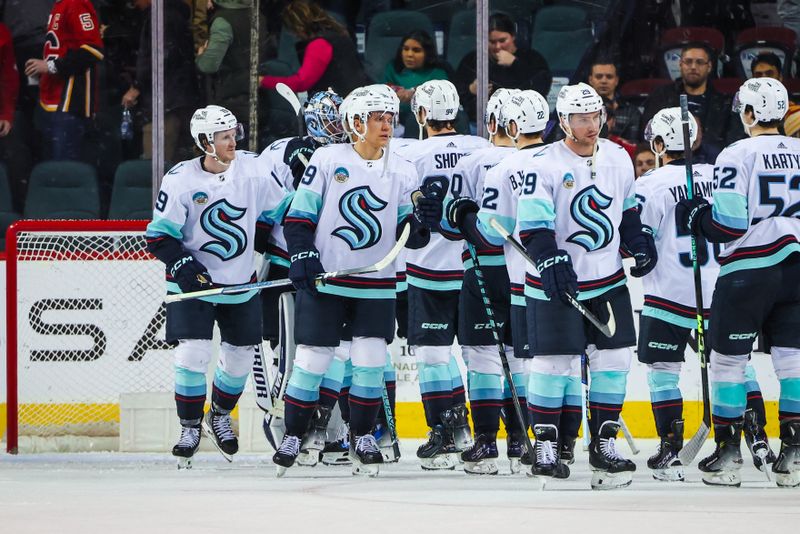 Dec 27, 2023; Calgary, Alberta, CAN; Seattle Kraken players celebrates win over Calgary Flames at Scotiabank Saddledome. Mandatory Credit: Sergei Belski-USA TODAY Sports