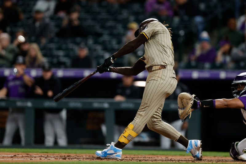 Apr 22, 2024; Denver, Colorado, USA; San Diego Padres right fielder Fernando Tatis Jr. (23) hits a triple in the seventh inning against the Colorado Rockies at Coors Field. Mandatory Credit: Isaiah J. Downing-USA TODAY Sports