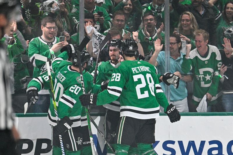 May 25, 2024; Dallas, Texas, USA; Dallas Stars center Ty Dellandrea (10) and left wing Mason Marchment (27) and defenseman Ryan Suter (20) and defenseman Alexander Petrovic (28) celebrate the game winning goal scored by left wing Mason Marchment (27) against the Edmonton Oilers during the third period in game two of the Western Conference Final of the 2024 Stanley Cup Playoffs at American Airlines Center. Mandatory Credit: Jerome Miron-USA TODAY Sports