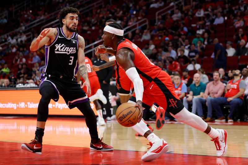 HOUSTON, TEXAS - NOVEMBER 06: Aaron Holiday #0 of the Houston Rockets drives against Chris Duarte #3 of the Sacramento Kings during the first half at Toyota Center on November 06, 2023 in Houston, Texas. (Photo by Carmen Mandato/Getty Images)