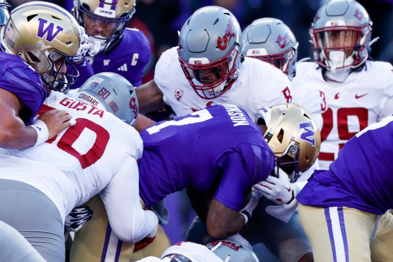 Nov 25, 2023; Seattle, Washington, USA; Washington Huskies running back Dillon Johnson (7) rushes for a touchdown against Washington State Cougars linebacker Devin Richardson (8) during the first quarter at Alaska Airlines Field at Husky Stadium. Mandatory Credit: Joe Nicholson-USA TODAY Sports