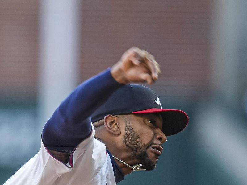 Apr 21, 2024; Cumberland, Georgia, USA; Atlanta Braves starting pitcher Darius Vines (61) pitches against the Texas Rangers during the first inning at Truist Park. Mandatory Credit: Dale Zanine-USA TODAY Sports