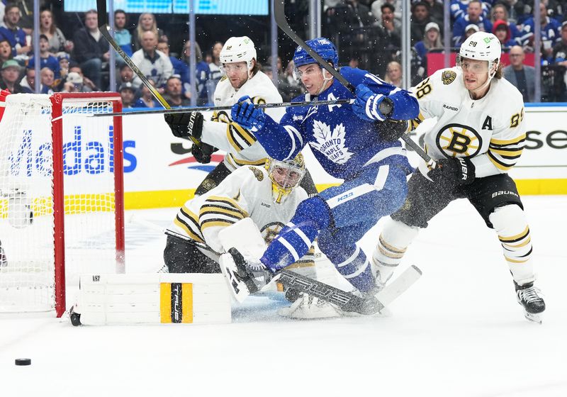 Apr 27, 2024; Toronto, Ontario, CAN; Toronto Maple Leafs right wing Mitch Marner (16) battles for the puck with Boston Bruins right wing David Pastrnak (88) in front of  goaltender Jeremy Swayman (1) during the first period in game four of the first round of the 2024 Stanley Cup Playoffs at Scotiabank Arena. Mandatory Credit: Nick Turchiaro-USA TODAY Sports