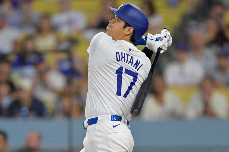 Sep 6, 2024; Los Angeles, California, USA;  Los Angeles Dodgers designated hitter Shohei Ohtani (17) hits a long fly ball for an out in the first inning against the Cleveland Guardians at Dodger Stadium. Mandatory Credit: Jayne Kamin-Oncea-Imagn Images