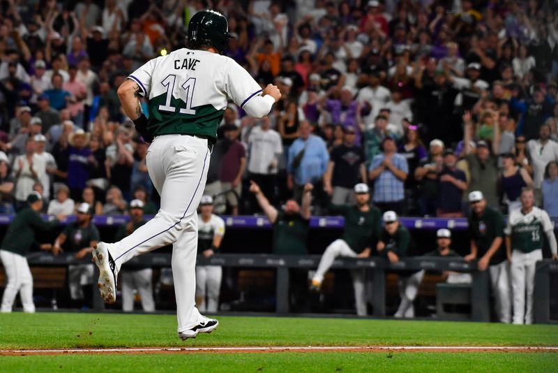 Jun 22, 2024; Denver, Colorado, USA; Colorado Rockies outfielder Jake Cave (11) heads home with the game wining run after a pitch timer violation against the Washington Nationals in the ninth inning at Coors Field. Mandatory Credit: John Leyba-USA TODAY Sports