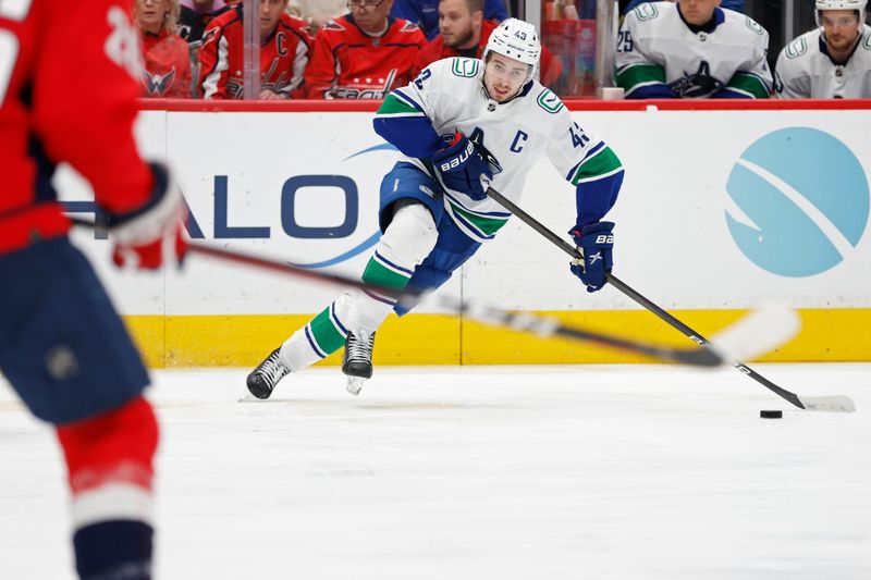 Feb 11, 2024; Washington, District of Columbia, USA; Vancouver Canucks defenseman Quinn Hughes (43) skates with the puck against the Washington Capitals in the second period at Capital One Arena. Mandatory Credit: Geoff Burke-USA TODAY Sports