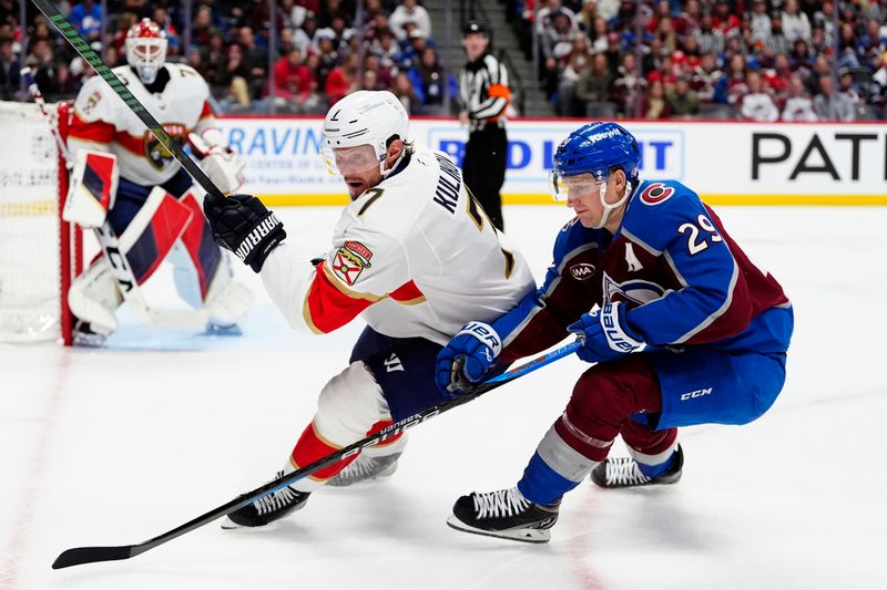 Jan 6, 2025; Denver, Colorado, USA; Florida Panthers defenseman Dmitry Kulikov (7) and Colorado Avalanche center Nathan MacKinnon (29) battle for control of a loose puck in the second period at Ball Arena. Mandatory Credit: Ron Chenoy-Imagn Images