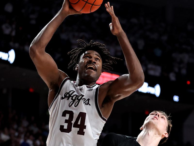 Jan 18, 2023; College Station, Texas, USA; Texas A&M Aggies forward Julius Marble (34) shoots the ball while Florida Gators forward Colin Castleton (12) defends during the second half at Reed Arena. Mandatory Credit: Erik Williams-USA TODAY Sports
