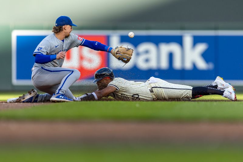 May 29, 2024; Minneapolis, Minnesota, USA; Minnesota Twins center fielder Willi Castro (50) slides into second base for a double before Kansas City Royals shortstop Bobby Witt Jr. (7) can make a tag in the second inning at Target Field. Mandatory Credit: Jesse Johnson-USA TODAY Sports