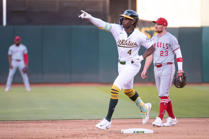 Jul 2, 2024; Oakland, California, USA; Oakland Athletics outfielder Lawrence Butler (4) points to the crowd after hitting a home run against the Los Angeles Angels during the fourth inning at Oakland-Alameda County Coliseum. Mandatory Credit: Ed Szczepanski-USA TODAY Sports