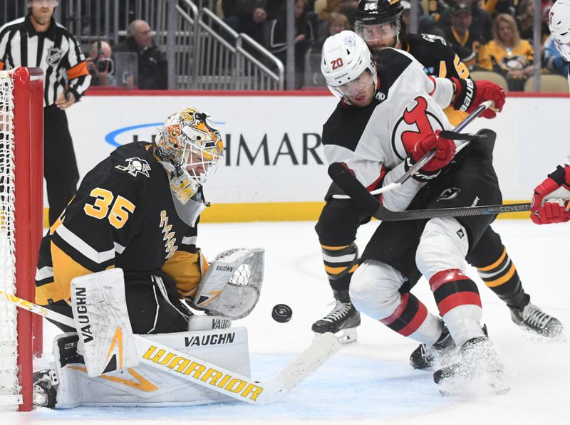 Nov 16, 2023; Pittsburgh, Pennsylvania, USA; Pittsburgh Penguins goalie Tristan Jarry (35) stops New Jersey Devils center Michael McLeod (20) during the second period at PPG Paints Arena. Mandatory Credit: Philip G. Pavely-USA TODAY Sports