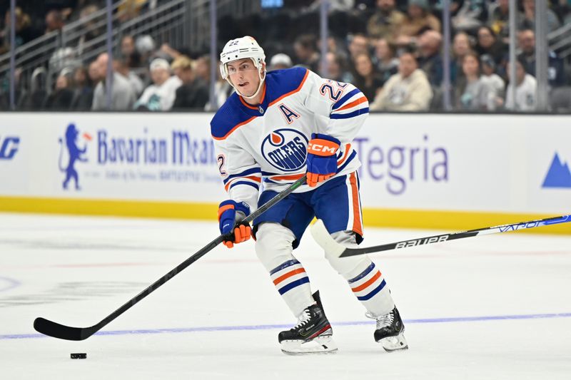 Sep 26, 2022; Seattle, Washington, USA; Edmonton Oilers defenseman Oliver Bjorkstrand (22) advances the puck during the first period against the Seattle Kraken at Climate Pledge Arena. Mandatory Credit: Steven Bisig-USA TODAY Sports