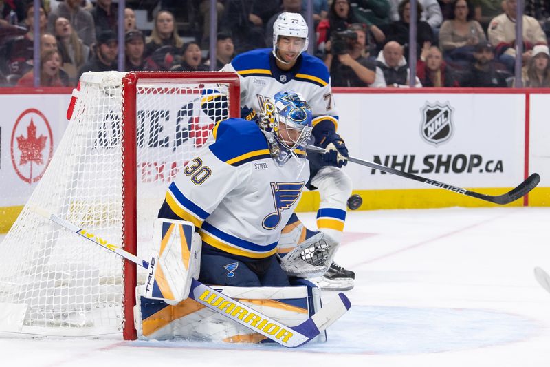 Oct 29, 2024; Ottawa, Ontario, CAN; St. Louis Blues goalie Jordan Binnington (30) makes a save in the first period against the Ottawa Senators at the Canadian Tire Centre. Mandatory Credit: Marc DesRosiers-Imagn Images