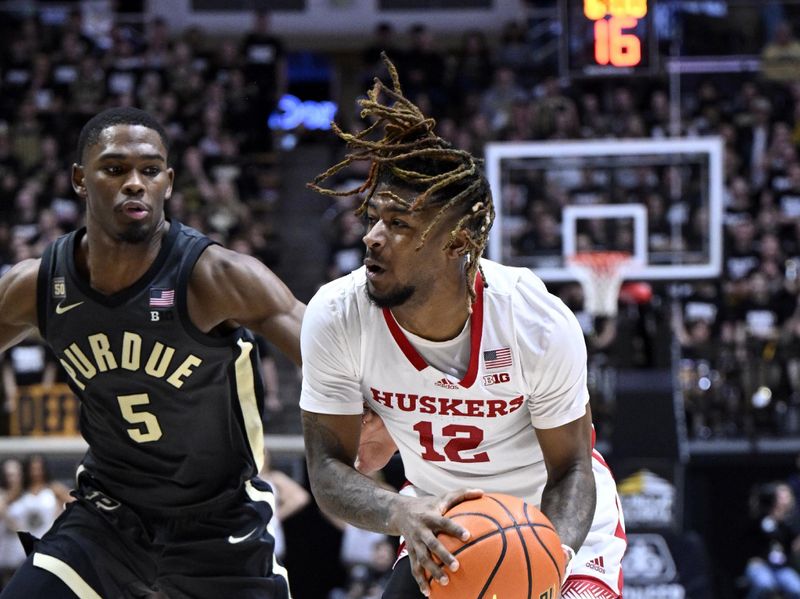 Jan 13, 2023; West Lafayette, Indiana, USA;  Nebraska Cornhuskers guard Denim Dawson (12) drives toward the basket against Purdue Boilermakers guard Brandon Newman (5) during the first half at Mackey Arena. Mandatory Credit: Marc Lebryk-USA TODAY Sports