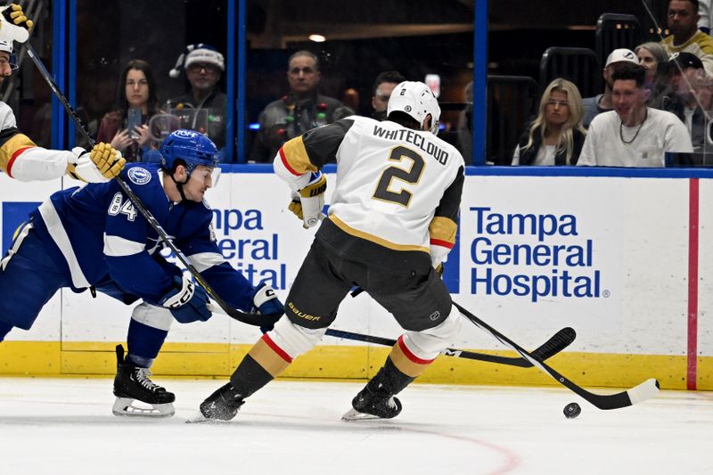 Dec 21, 2023; Tampa, Florida, USA; Tampa Bay Lightning left wing Tanner Jeannot (84) attempts to get past Las Vegas Golden Knights defensemen Zach Whitecloud (2) in the first period at Amalie Arena. Mandatory Credit: Jonathan Dyer-USA TODAY Sports