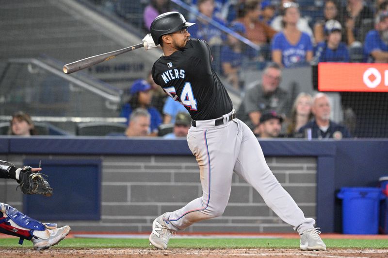 Sep 28, 2024; Toronto, Ontario, CAN; Miami Marlins center fielder Dane Myers (54) hits a three run home run against the Toronto Blue Jays in the eighth inning at Rogers Centre. Mandatory Credit: Dan Hamilton-Imagn Images