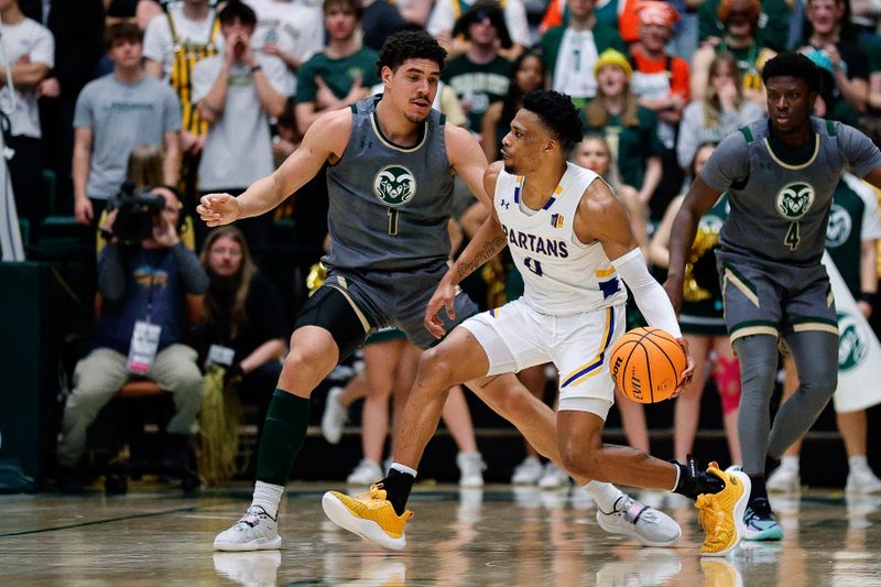 Feb 9, 2024; Fort Collins, Colorado, USA; San Jose State Spartans guard Myron Amey Jr. (0) controls the ball as Colorado State Rams forward Joel Scott (1) guards in the second half at Moby Arena. Mandatory Credit: Isaiah J. Downing-USA TODAY Sports