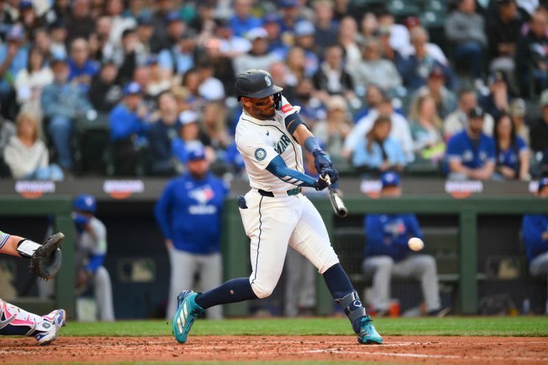 May 10, 2025; Seattle, Washington, USA; Seattle Mariners center fielder Julio Rodriguez (44) hits a single against the Toronto Blue Jays during the fourth inning at T-Mobile Park. Mandatory Credit: Steven Bisig-Imagn Images
