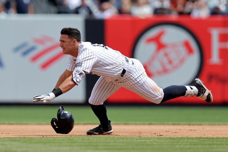 May 23, 2024; Bronx, New York, USA; New York Yankees shortstop Anthony Volpe (11) slides into second for a double against the Seattle Mariners during the seventh inning at Yankee Stadium. Mandatory Credit: Brad Penner-USA TODAY Sports