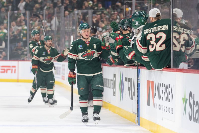 Apr 18, 2024; Saint Paul, Minnesota, USA; Minnesota Wild left wing Kirill Kaprizov (97) is congratulated by teammates after scoring on the Seattle Kraken in the first period at Xcel Energy Center. Mandatory Credit: Matt Blewett-USA TODAY Sports