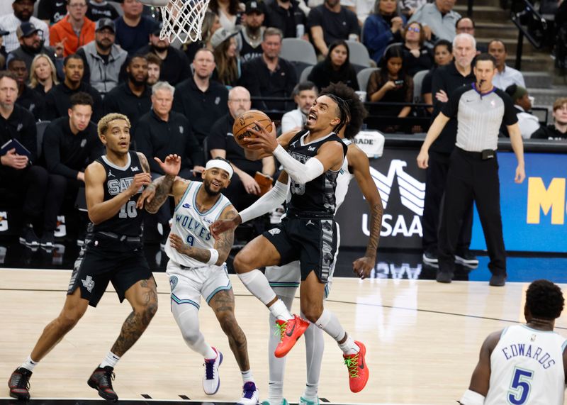 SAN ANTONIO, TX - JANUARY  27:  Tre Jones #33 of the San Antonio Spurs drives on the Minnesota Timberwolves in the first half at Frost Bank Center on January 27, 2024 in San Antonio, Texas. NOTE TO USER: User expressly acknowledges and agrees that, by downloading and or using this photograph, User is consenting to terms and conditions of the Getty Images License Agreement. (Photo by Ronald Cortes/Getty Images)