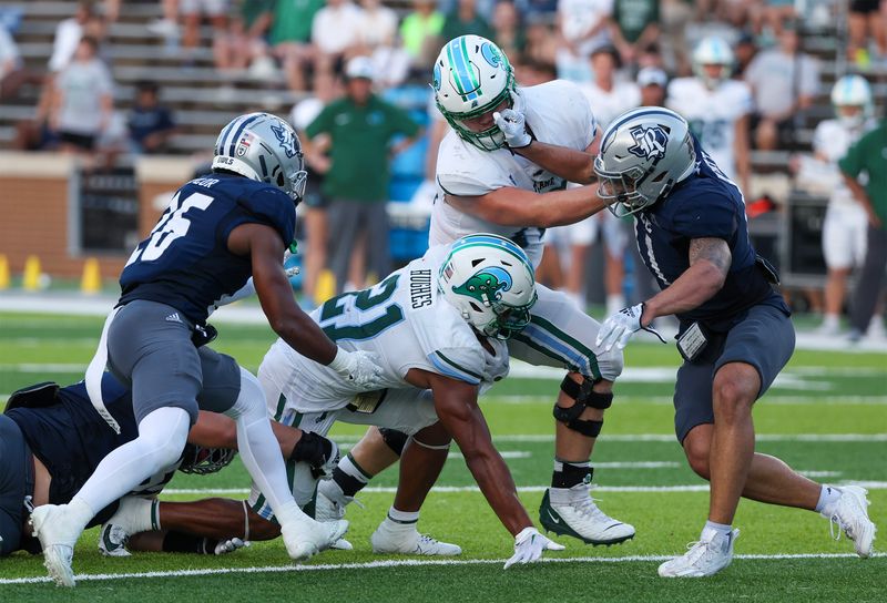 Oct 28, 2023; Houston, Texas, USA;Tulane Green Wave running back Makhi Hughes (21) rushes against Rice Owls defensive back AJ Stephens (25)  in the second half at Rice Stadium. Mandatory Credit: Thomas Shea-USA TODAY Sports