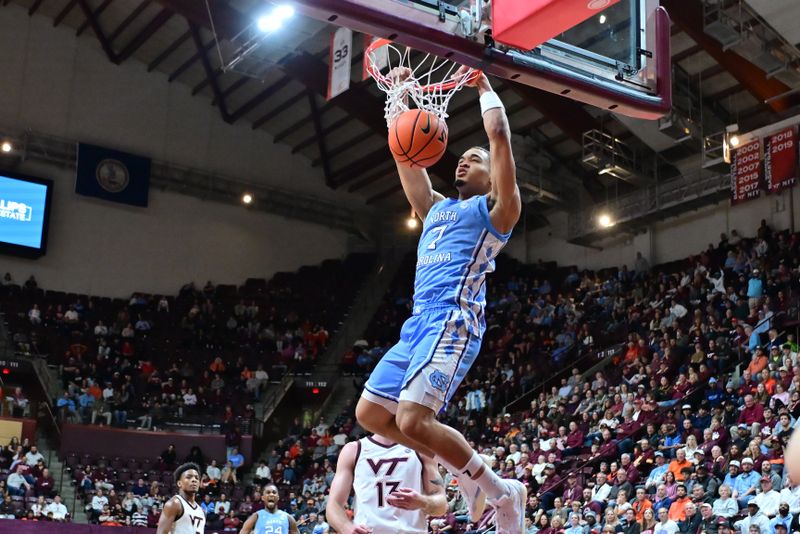 Mar 4, 2025; Blacksburg, Virginia, USA;  North Carolina Tar Heels guard Seth Trimble (7) dunks the ball against Virginia Tech Hokies during the second half at Cassell Coliseum. Mandatory Credit: Brian Bishop-Imagn Images