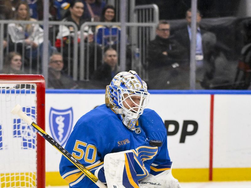 Apr 5, 2025; St. Louis, Missouri, USA;  St. Louis Blues goaltender Jordan Binnington (50) defends the net against the Colorado Avalanche during the first period at Enterprise Center. Mandatory Credit: Jeff Curry-Imagn Images