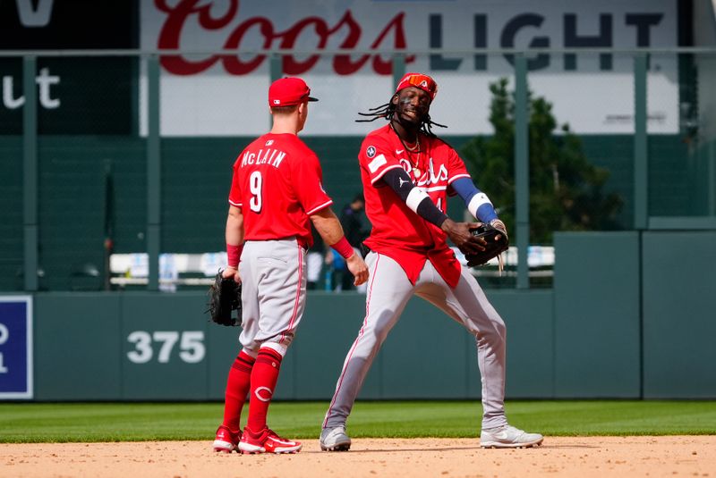 Apr 26, 2025; Denver, Colorado, USA; Cincinnati Reds second baseman Matt McLain (9) and shortstop Elly De La Cruz (44) celebrate defeating the Colorado Rockies at Coors Field. Mandatory Credit: Ron Chenoy-Imagn Images
