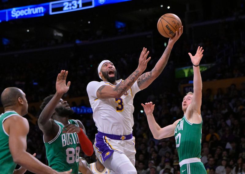 LOS ANGELES, CALIFORNIA - DECEMBER 25: Anthony Davis #3 of the Los Angeles Lakers drives past Neemias Queta #88 and JD Davison #20 of the Boston Celtics in the first half at Crypto.com Arena on December 25, 2023 in Los Angeles, California. NOTE TO USER: User expressly acknowledges and agrees that, by downloading and or using this photograph, User is consenting to the terms and conditions of the Getty Images License Agreement.(Photo by Jayne Kamin-Oncea/Getty Images)