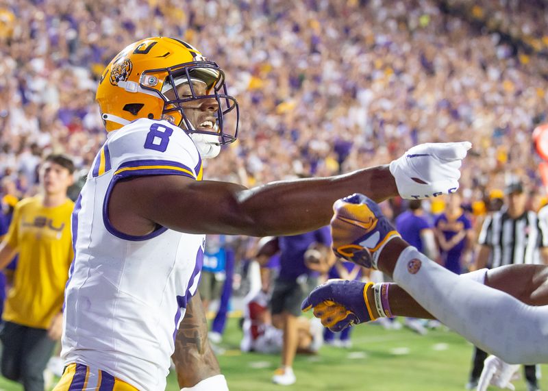 Sep 23, 2023; Baton Rouge, Louisiana, USA; LSU Tigers wide receiver Malik Nabers (8) celebrates after a touchdown against the Arkansas Razorbacks during the game at Tiger Stadium. Mandatory Credit: Scott Clause-USA TODAY Sports