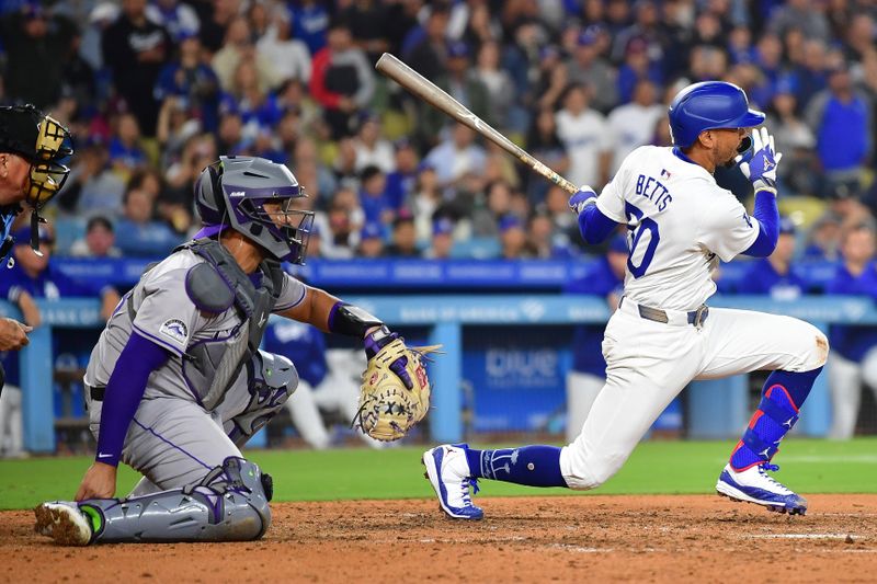 May 31, 2024; Los Angeles, California, USA; /Los Angeles Dodgers shortstop Mookie Betts (50) grounds out into a double play bringing in a run against the Colorado Rockies during the eighth inning at Dodger Stadium. Mandatory Credit: Gary A. Vasquez-USA TODAY Sports