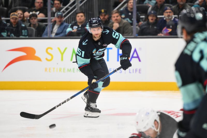 Jan 6, 2025; Seattle, Washington, USA; Seattle Kraken center Shane Wright (51) passes the puck against the New Jersey Devils during the third period at Climate Pledge Arena. Mandatory Credit: Steven Bisig-Imagn Images
