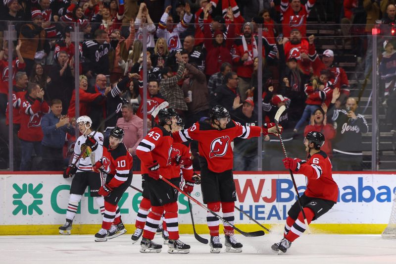 Jan 5, 2024; Newark, New Jersey, USA; New Jersey Devils center Michael McLeod (20) celebrates his goal against the Chicago Blackhawks during the third period at Prudential Center. Mandatory Credit: Ed Mulholland-USA TODAY Sports
