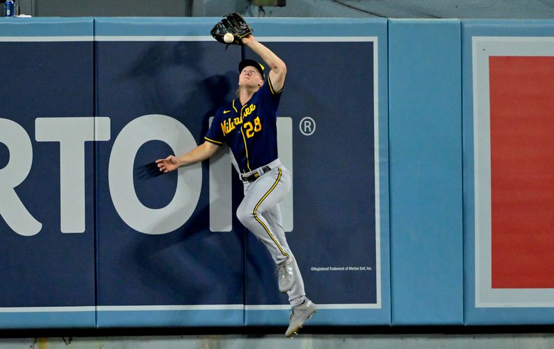 Aug 16, 2023; Los Angeles, California, USA;  A RBI double by Los Angeles Dodgers first baseman Freddie Freeman (5) gets by Milwaukee Brewers center fielder Joey Wiemer (28) in the sixth inning at Dodger Stadium. Mandatory Credit: Jayne Kamin-Oncea-USA TODAY Sports